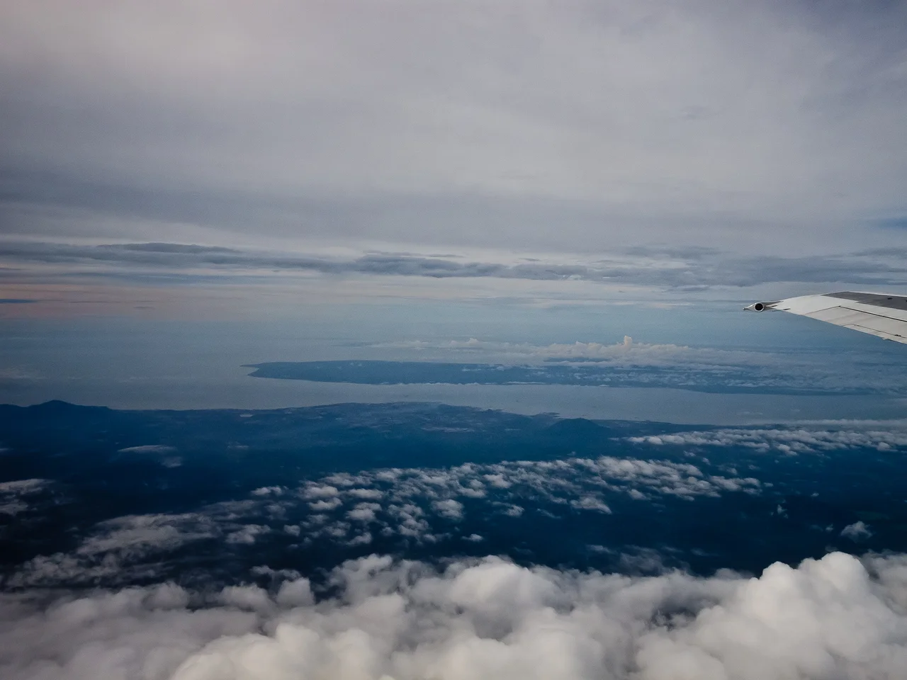 Aerial View of the entrance to Cowie Bay. In the background Sebatik Island. In the foreground, next to the sea, Tawau City. Taken from airplane, heading west