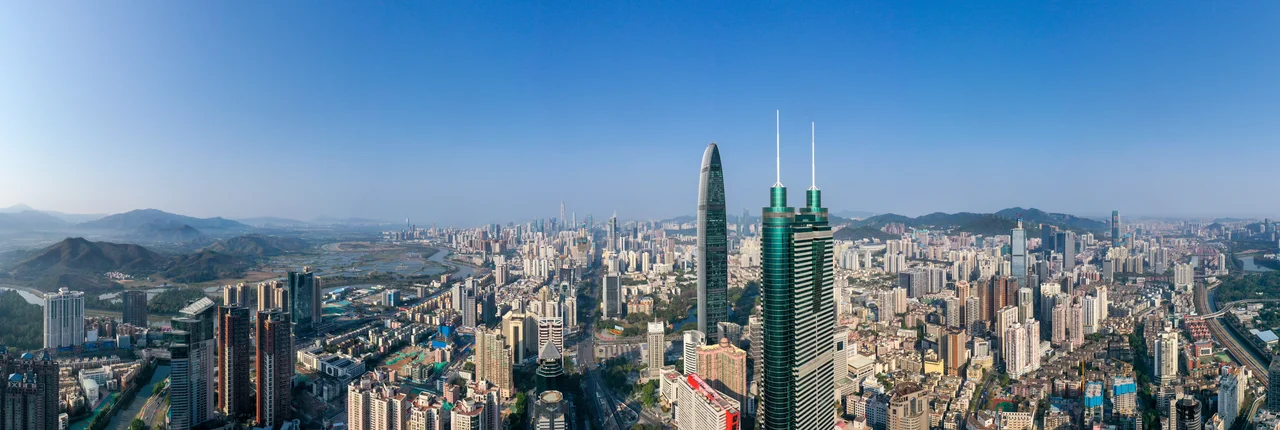 The west panorama of Shenzhen, Shennan road in the middle, Shenzhen river in the left, and Kowloon–Canton railway in the right.