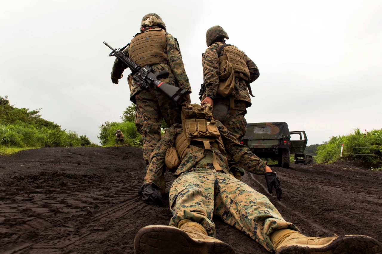 Marines with Combat Logistics Company 36 drag a casualty of an Improvised Explosive Device during Exercise Dragon Fire 2014 at Combined Arms Training Center Camp Fuji, Japan, July 19. While just a training event, Sgt. Paul Faucheux, an explosive ordnance disposal technician with Marine Corps Installations Pacific, said it provided junior Marines an introduction to IED strikes, allowed noncommissioned officers to teach, and challenged their combat leadership in countering IED strikes.
(U.S. Marine Corps photo by Cpl. Antonio Rubio/Released)